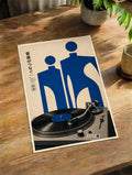 Paper wall art print with blue figures and vinyl record graphic on a turntable