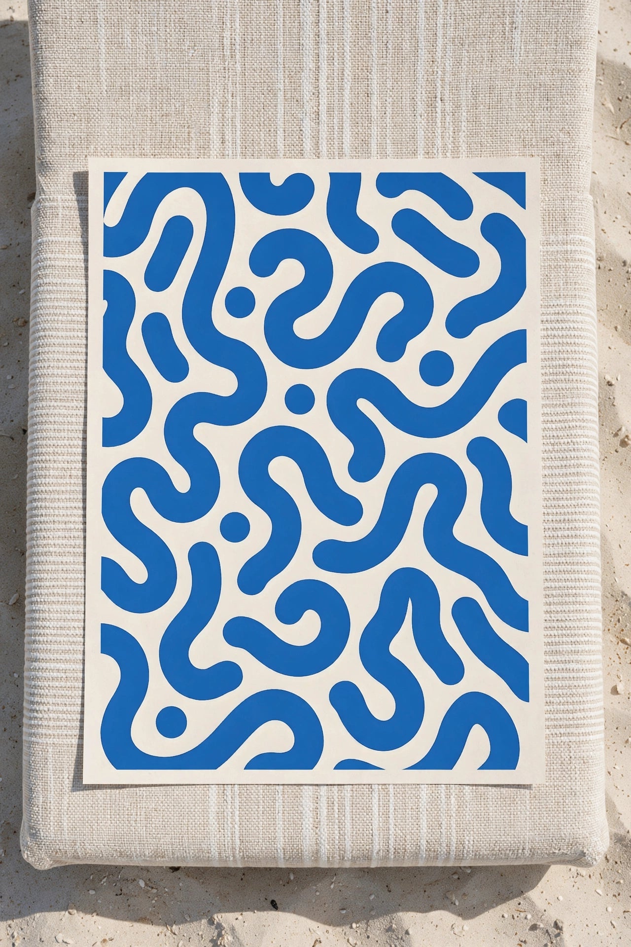 Blue abstract print with wavy ribbon-like shapes on a white background