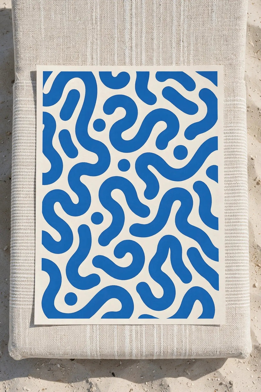 Blue abstract print with wavy ribbon-like shapes on a white background