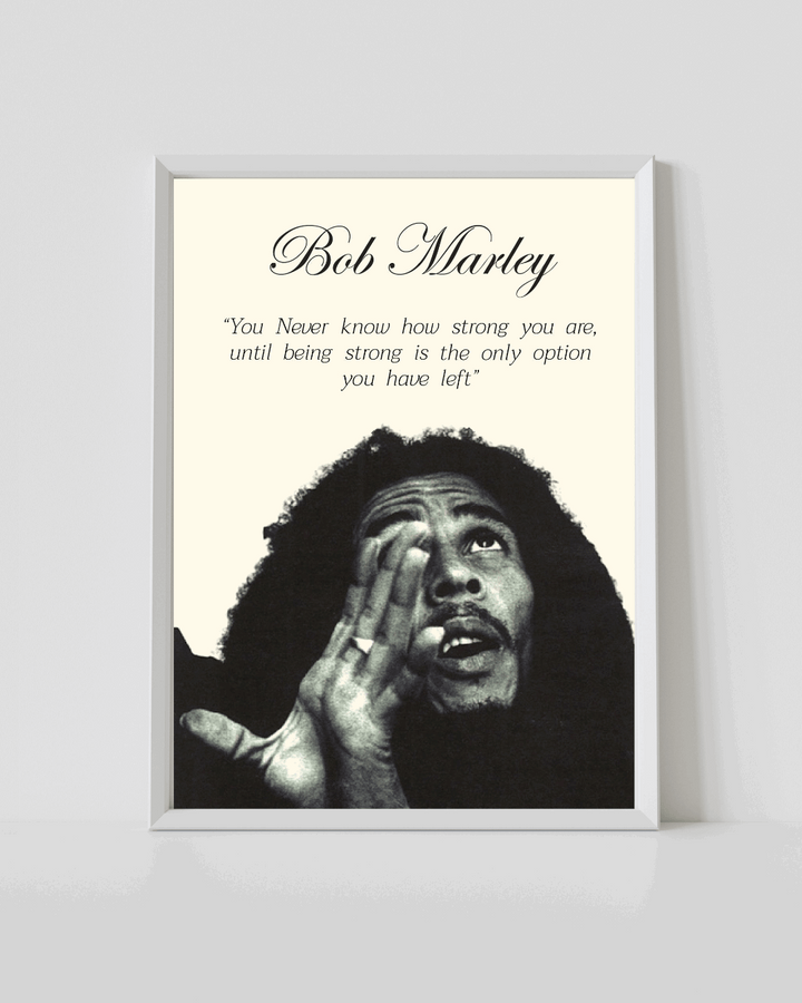 Bob Marley poster in white frame with black-and-white portrait and quote