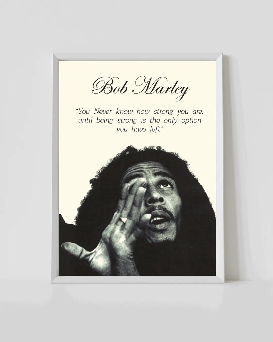 Bob Marley poster in white frame with black-and-white portrait and quote