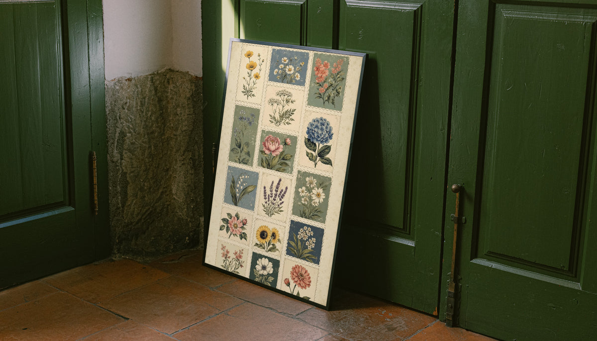 Patchwork of flower and leaf stamp style panels in sage blue pink and cream as an unframed print leaning against a green panelled door