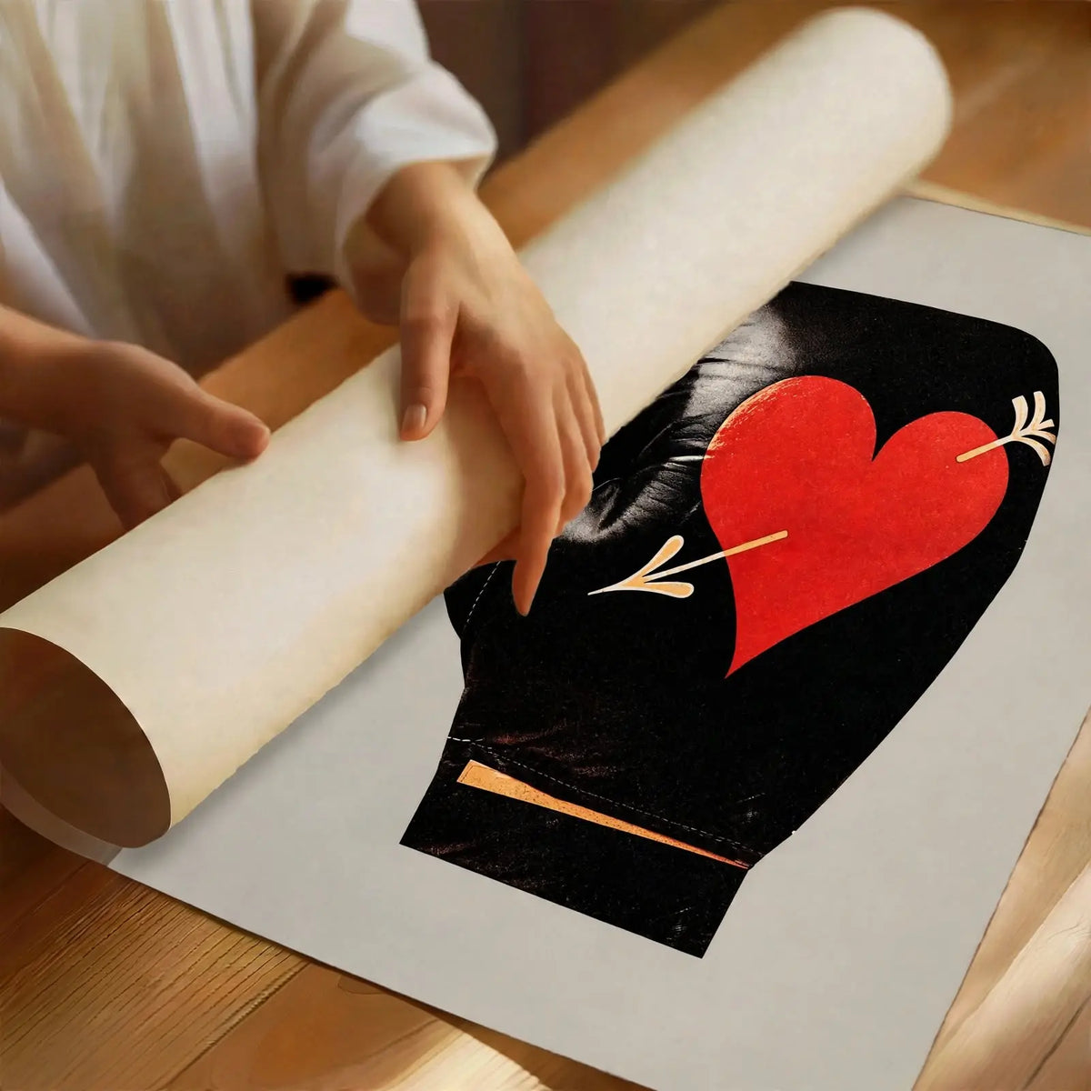 Boxing glove heart print on white paper, folded edges, viewed at an angle