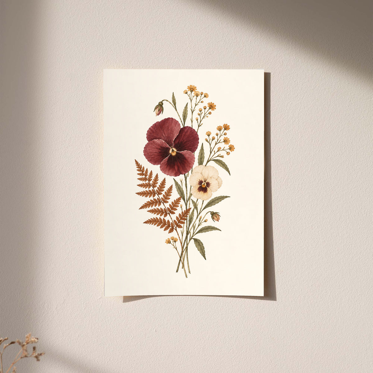 Burgundy and cream pansies with rust fern leaves and small golden flowers as an unframed hanging paper print against a plaster wall