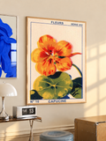 Framed floral poster with orange capucine flower and green leaves, beige background.