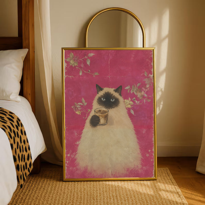 Gold-framed pink floral portrait of a fluffy cat holding a cup of coffee