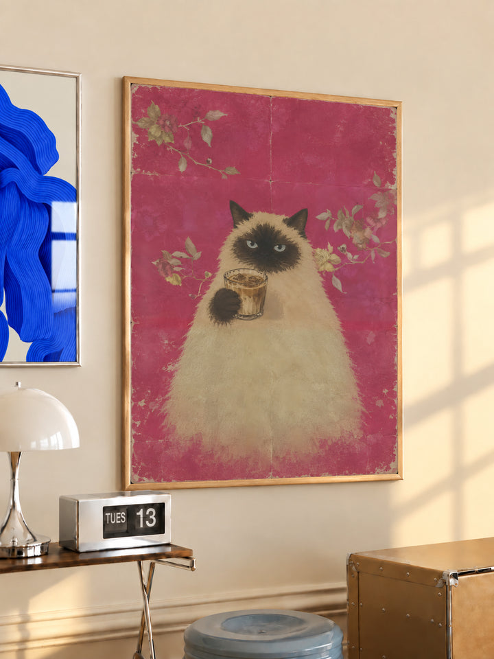 Gold-framed cat portrait holding a cup of coffee on pink floral background