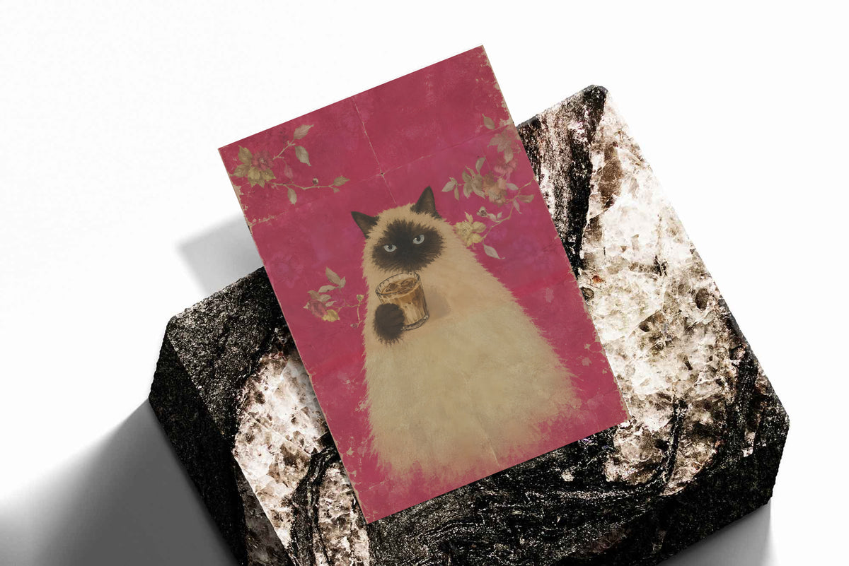 Angled art print featuring a fluffy cat holding a cup of coffee on pink floral background