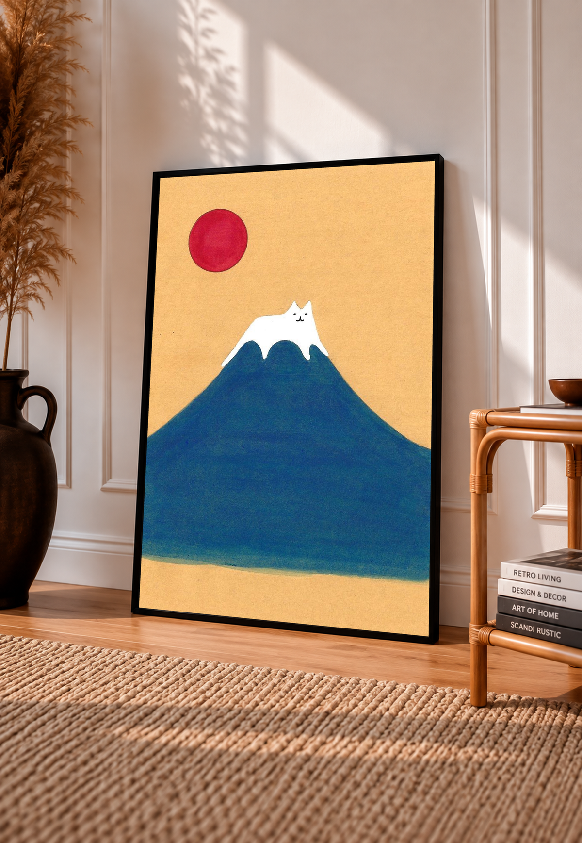 Black-framed art print with blue mountain, red sun, and white cat