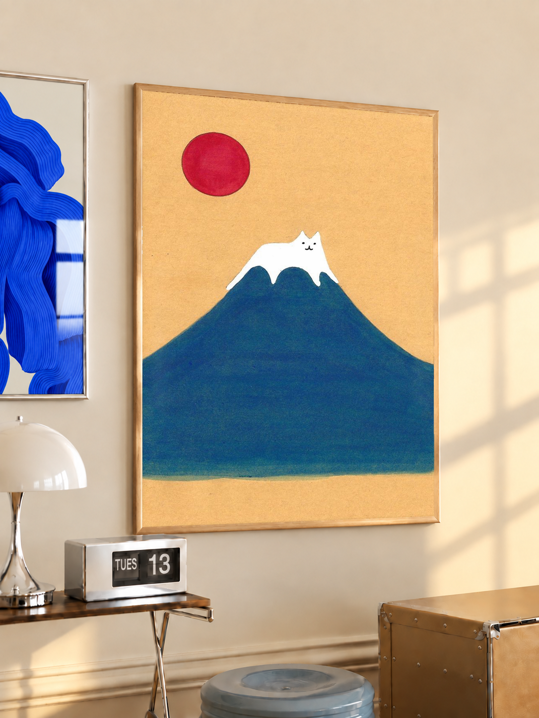 Framed art print of blue mountain, red sun, and white cat