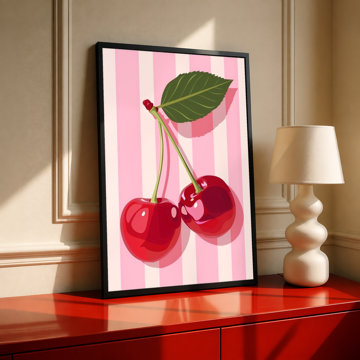 Black-framed cherry kitchen poster on a red surface, pink stripes with red cherries and leaf