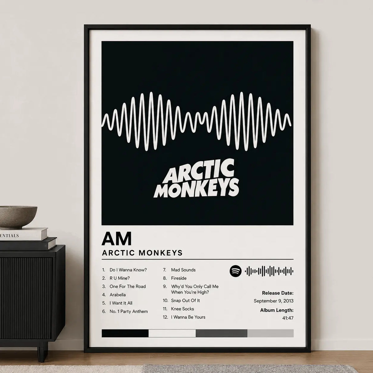 Custom album poster in black frame, waveform graphic with “ARCTIC MONKEYS” and track list
