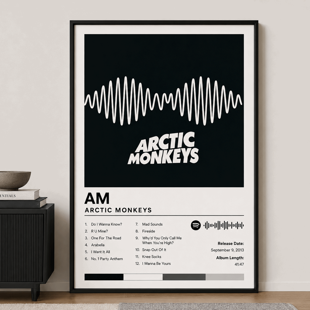 Custom album poster in black frame, waveform graphic with “ARCTIC MONKEYS” and track list