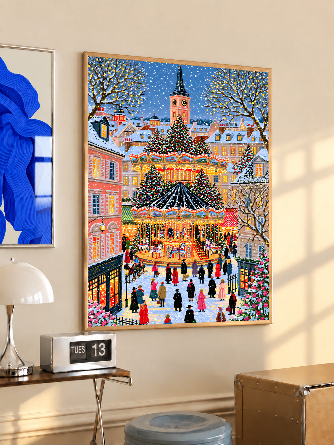 Christmas carousel art print in a light wood frame, showing a snowy square and festive carousel.