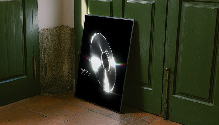 SIGNAL music graphic with a reflective silver grooved disc, white highlights and rainbow streaks on black, styled in a black frame against dark green paneled doors above orange floor tiles