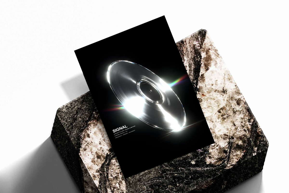 SIGNAL music graphic with a reflective silver grooved disc, white highlights and rainbow streaks on black, shown as an unframed print tilted on a dark stone display against a light background