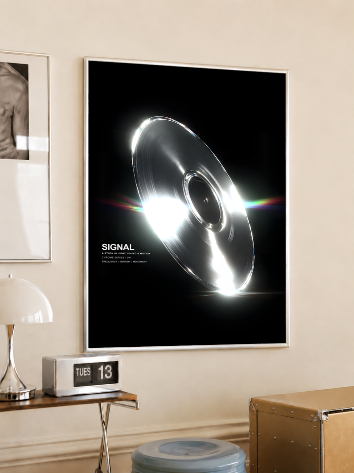 SIGNAL music graphic with a reflective silver grooved disc, white highlights and rainbow streaks on black, styled in a light frame on a cream wall beside a white dome lamp and glass side table