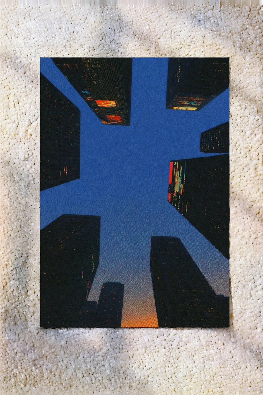 Square abstract city life artwork print with blue buildings and orange details