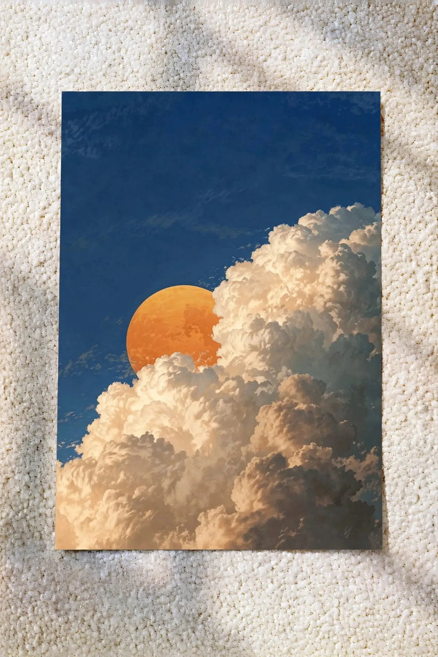 Wall art print with blue sky, orange moon, and fluffy white clouds