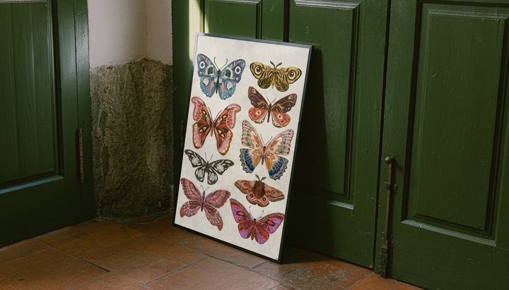 Colorful Butterfly & Moth Print shown as a canvas leaning beside green panels on a wooden floor.