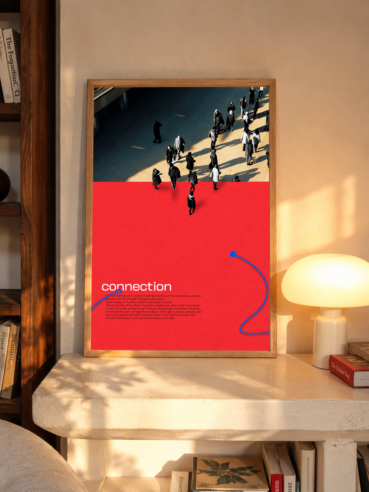 Street pedestrians above a red field with Connection text and two blue cable shapes in an oak frame above a pale wooden sideboard beside a glowing lamp