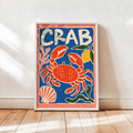 Framed crab wall art poster: blue background with red crab, shells, and 'CRAB' in white frame
