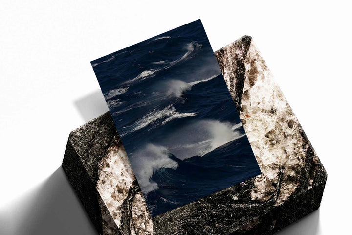 Unframed ocean waves print on dark blue water with white crests and mist