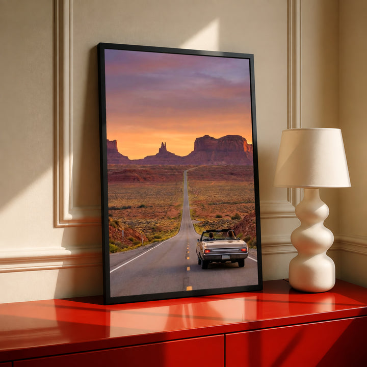 Desert road poster in black frame with convertible car at desert sunset