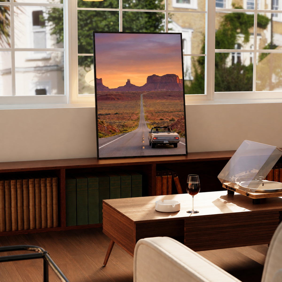 Desk-side desert road poster with black frame showing convertible car at sunset