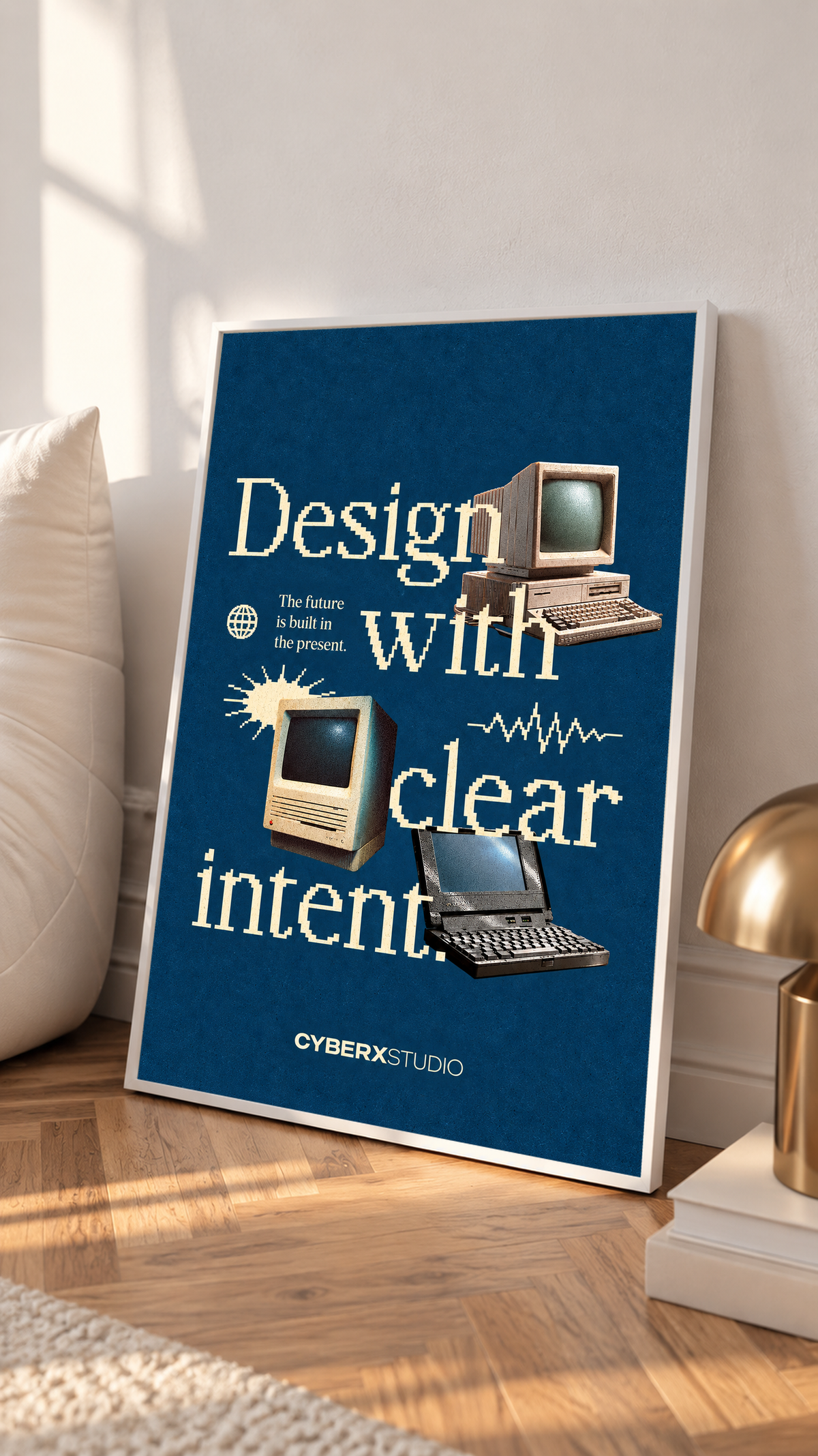 Vintage desktop computers and a laptop with cream pixel-style typography on blue in a white frame on a sunlit floor beside a white cabinet