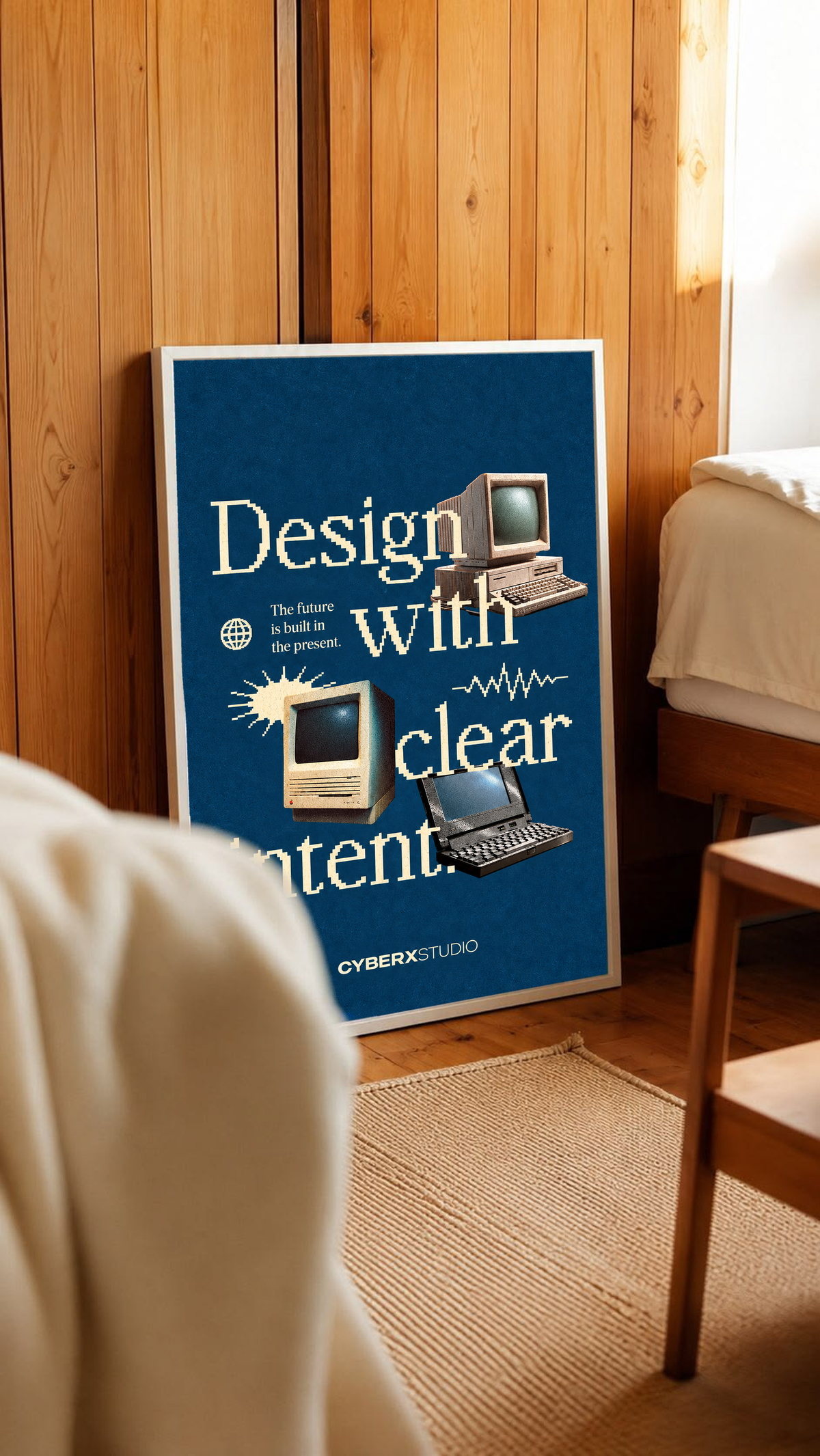 Vintage desktop computers and a laptop with cream pixel-style typography on blue in a white frame leaning against warm wooden wall panels