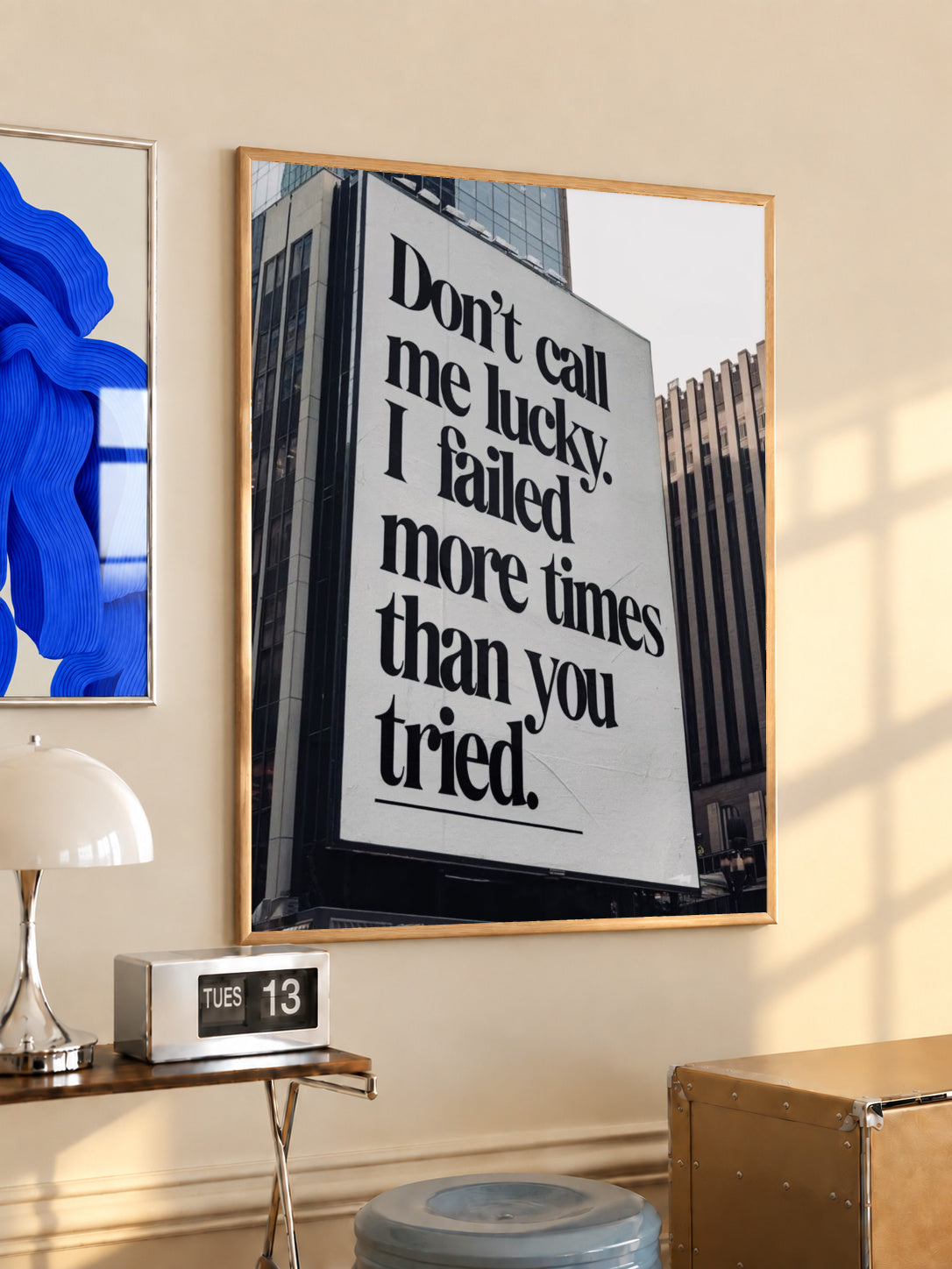 Black-and-white quote wall art poster in dark frame, reading “Don't call me lucky”