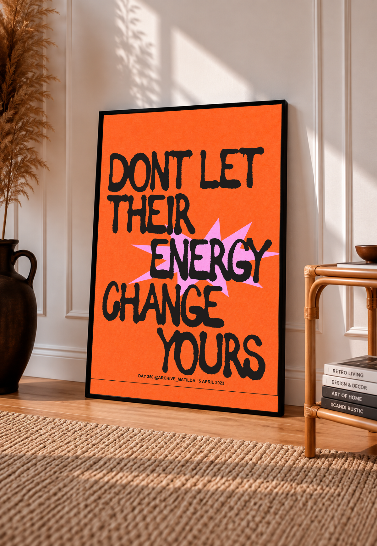 Orange poster with black border, bold quote lettering in black and pink with graphic shapes