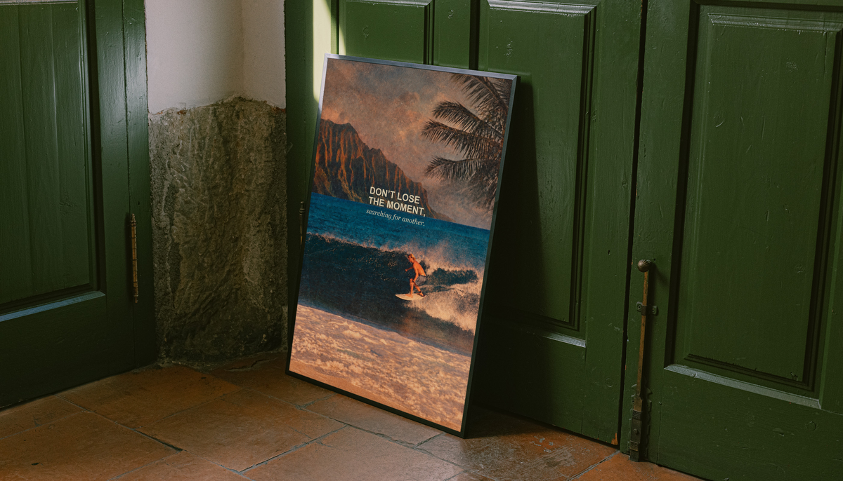 Surfer on a teal wave below warm sunset sky and palm fronds; unframed canvas styled by a green doorway