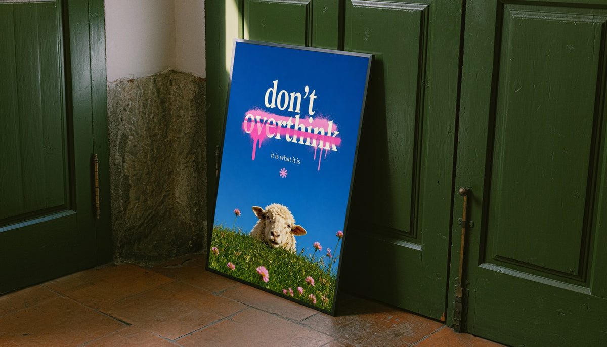 Standing framed poster with sheep in grass, pink flowers, and “don’t overthink” quote