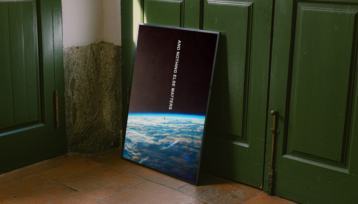 And Nothing Else Matters white vertical typography over Earth’s blue atmospheric horizon and a tiny human-shaped silhouette, styled in a black frame against dark green paneled doors above orange floor tiles