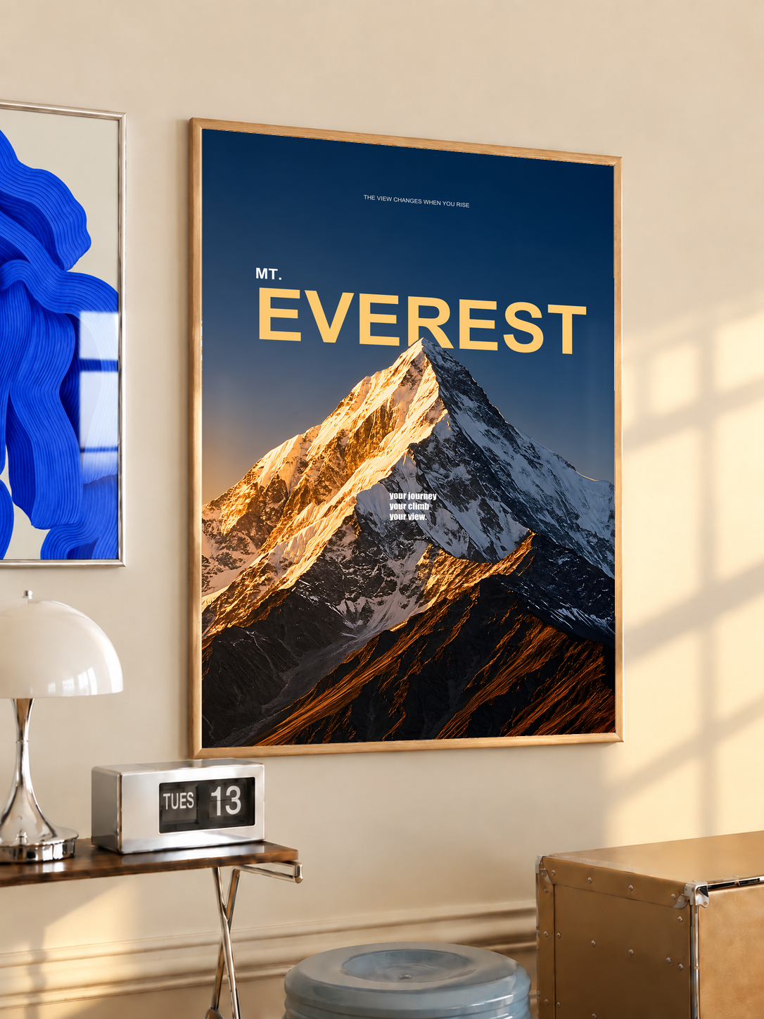 Golden light on a snowy Everest summit with yellow lettering on dark navy; oak framed print in a desk setting