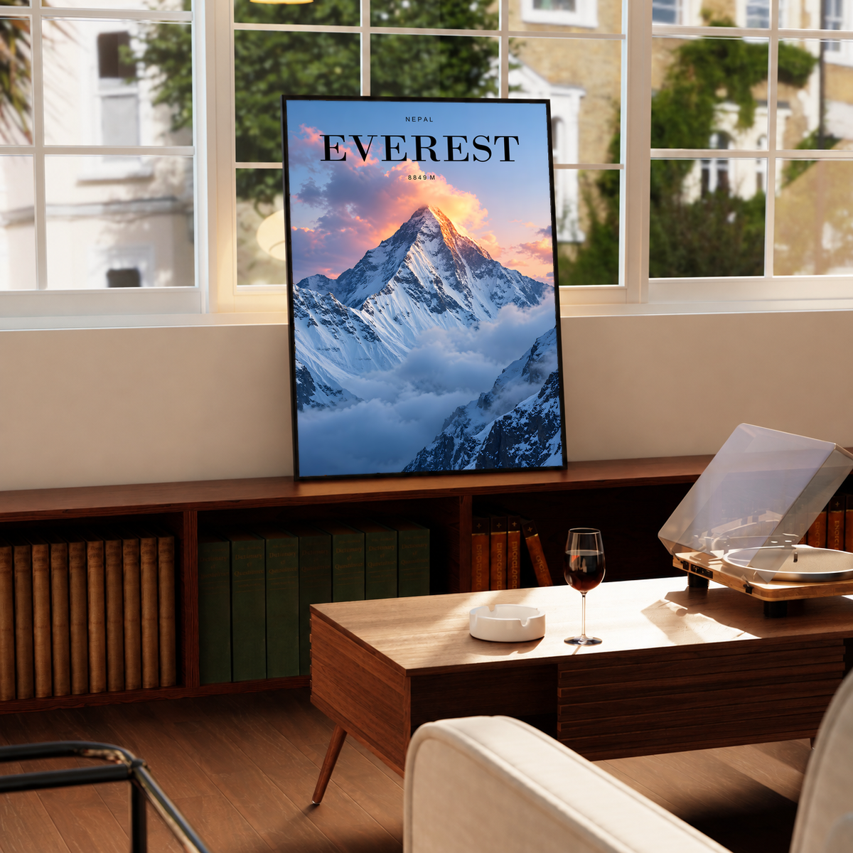 Snowy Everest peak rising through pink sunrise clouds; framed print beside a window