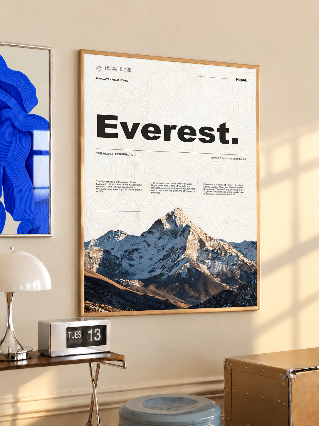 Everest topographic poster in a light wood frame with mountain photography and expedition typography.