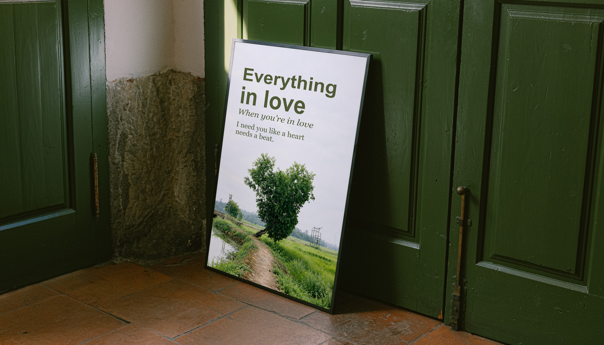 Heart-shaped green tree beside a rural path with Everything in Love lettering; unframed canvas styled by a green doorway