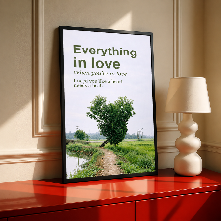 Black-framed love poster with heart-shaped green tree on landscape path