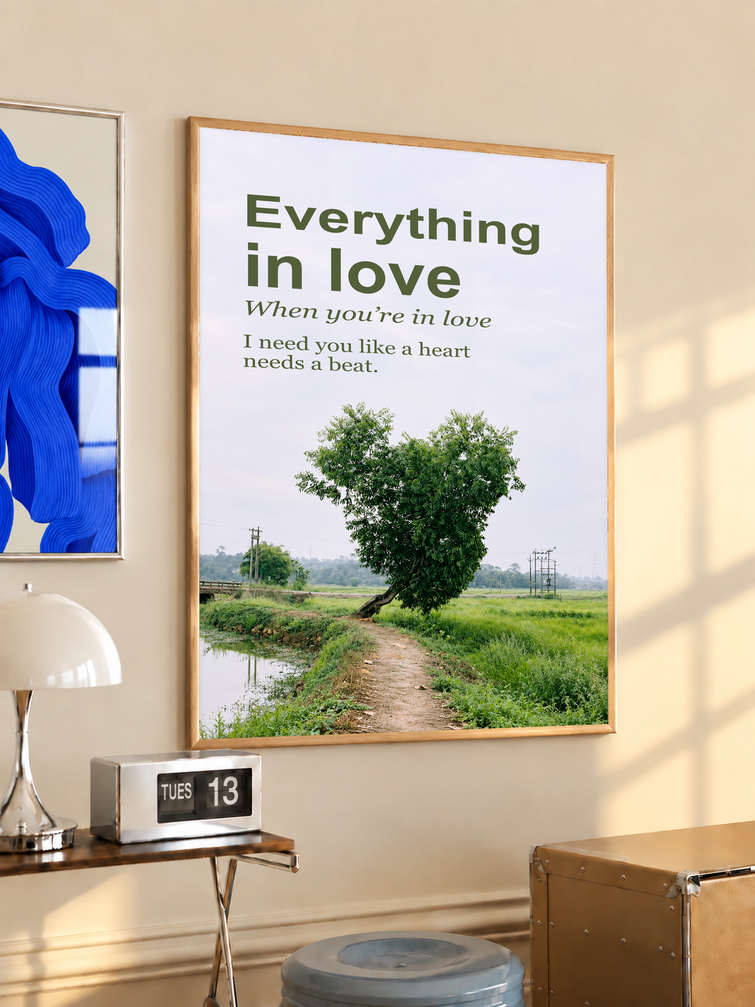 Heart-shaped green tree beside a rural path with Everything in Love lettering; oak framed print in a desk setting