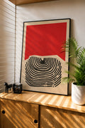 Framed fingerprint lines abstract art print with red and black geometric shapes.