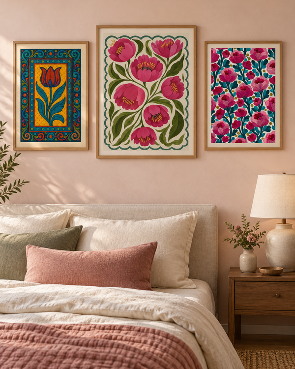 Three framed botanical prints with pink and teal florals, brown wood frames