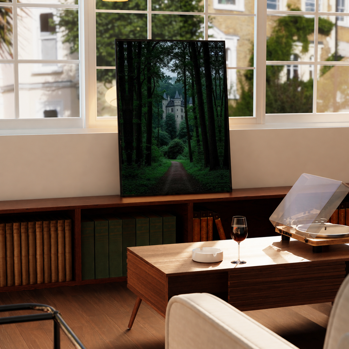 Forest Castle Poster in a black frame near a window and wooden table in a sunlit sitting room.
