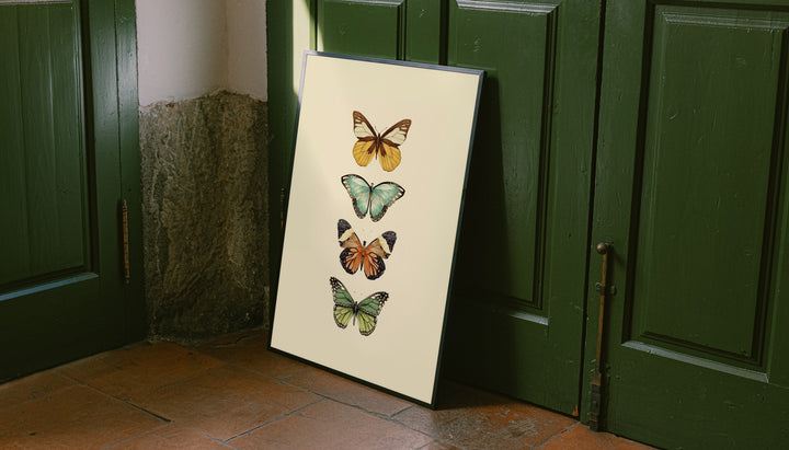 White-framed four-butterfly illustration print with warm cream background and green-blue butterflies