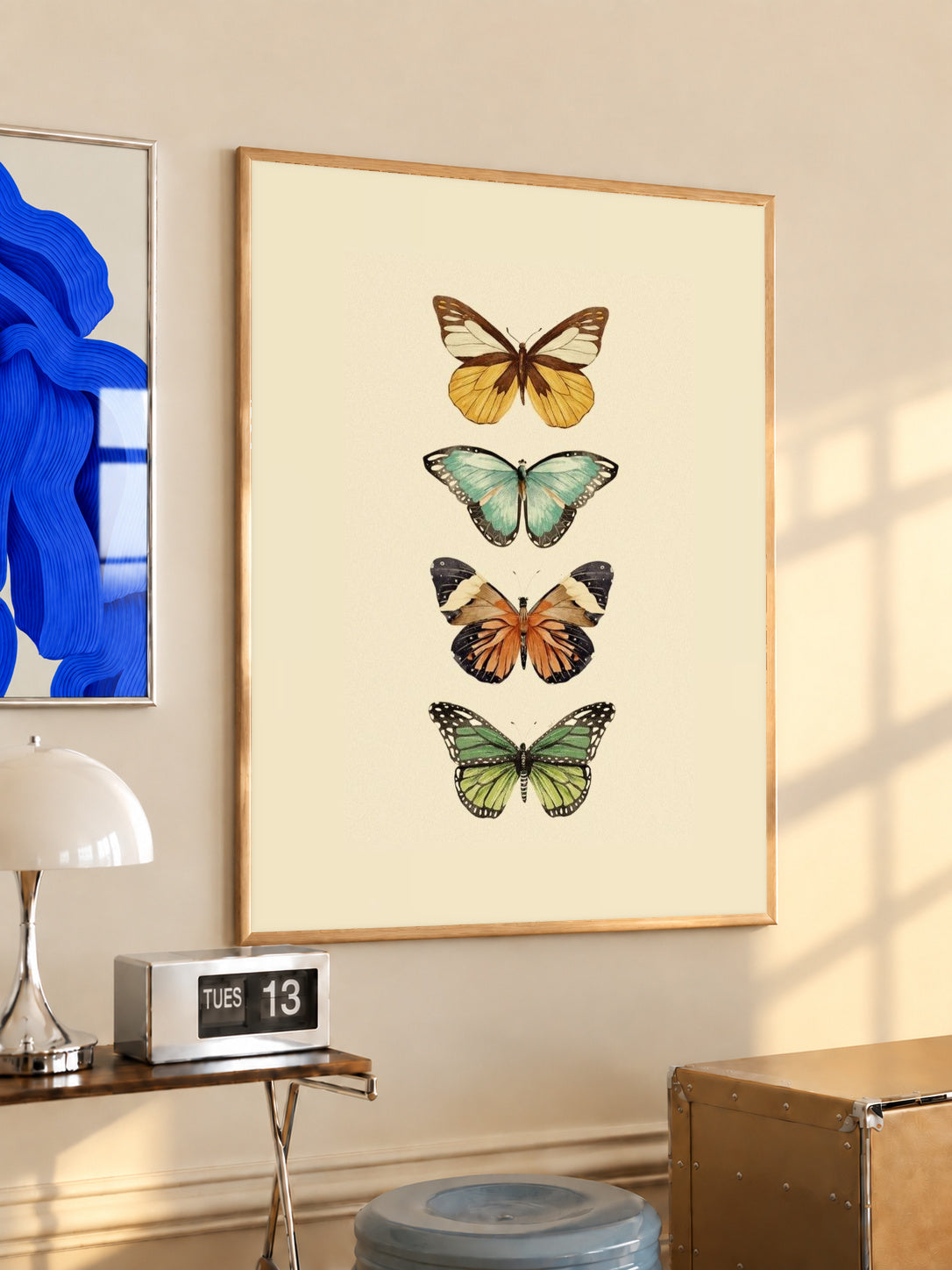 Framed four-butterfly illustration print on warm cream background, wood frame, gold and aqua