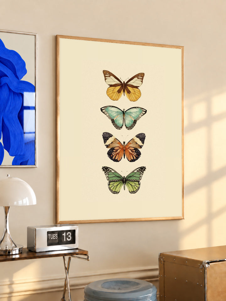 Framed four-butterfly illustration print on warm cream background, wood frame, gold and aqua