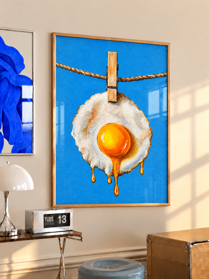 Fried egg hanging on a clothesline wall art displayed in styled interior view 3