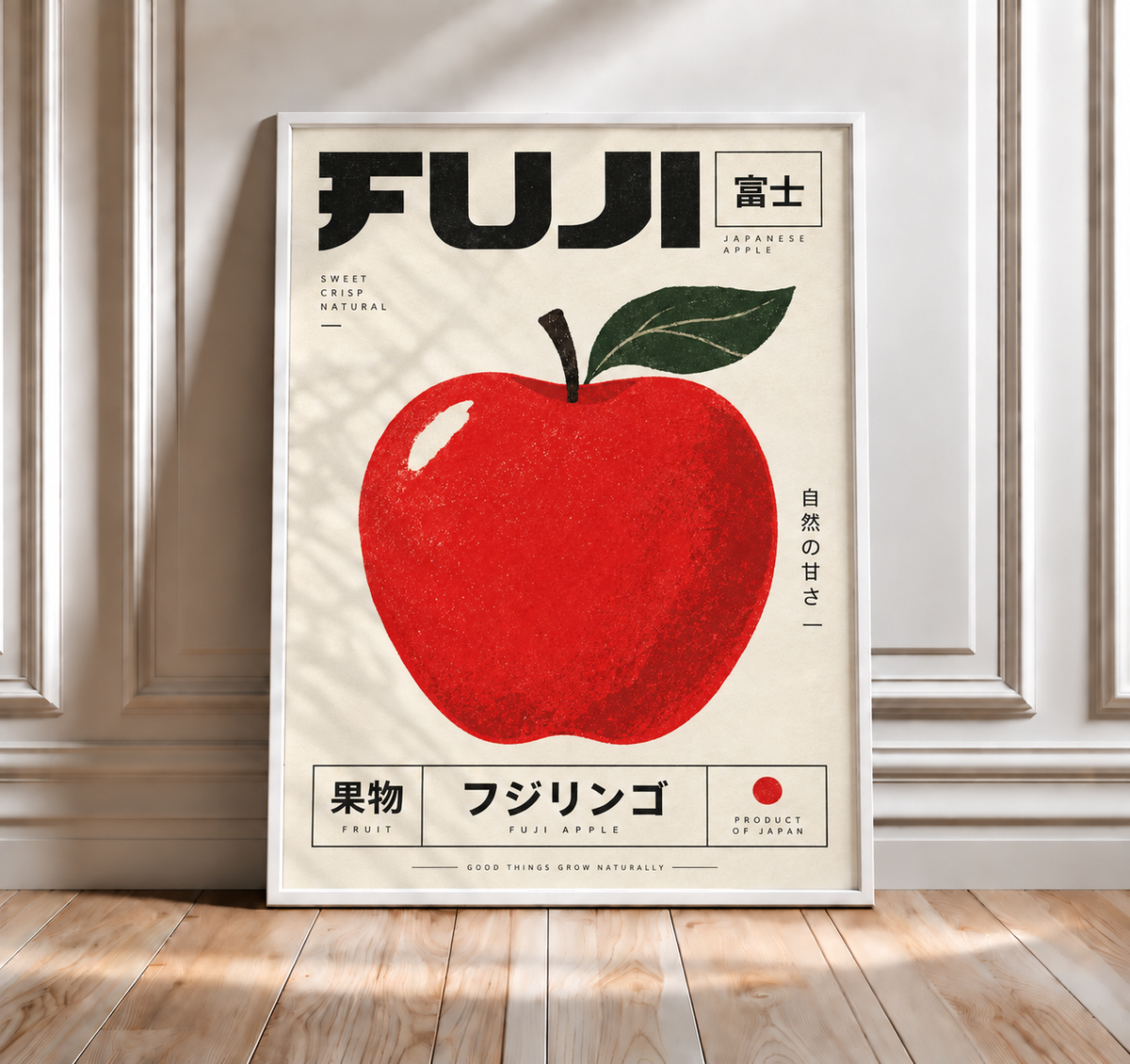 Framed red apple wall art print with green leaves and Japanese text on white frame.